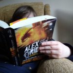 Boy reads Scorpio Rising Alex Rider Book 9 book middle grade fiction children's fiction action spy adventure