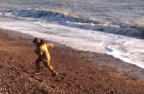 child running on beach